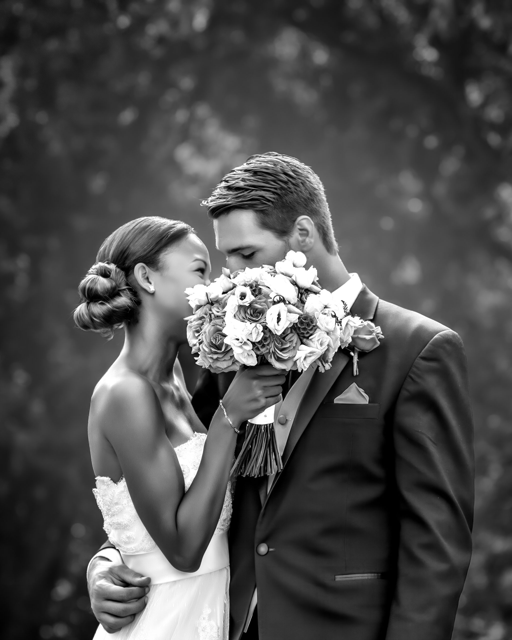 Bride and groom in an intimate embrace after their San Antonio wedding, holding a bouquet of flowers